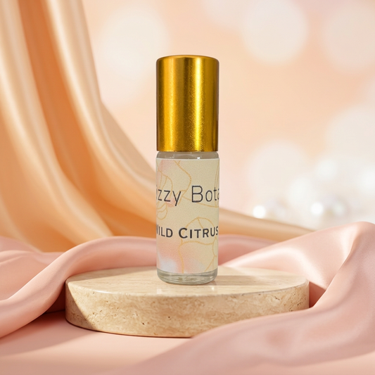 Perfume roller with pastel peach and blush satin background