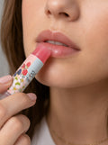 Model applying Berry Bliss lip balm