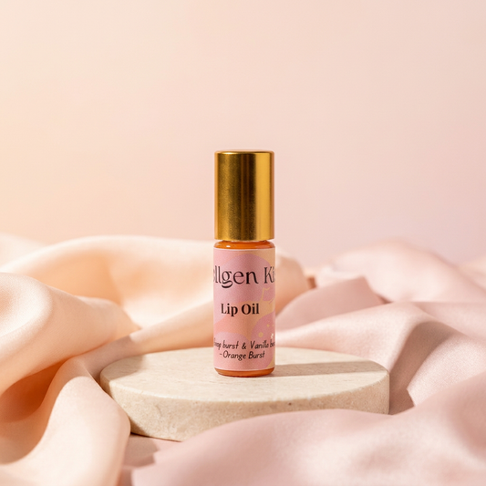 Orange Burst lip oil with a peach-and-blush satin background