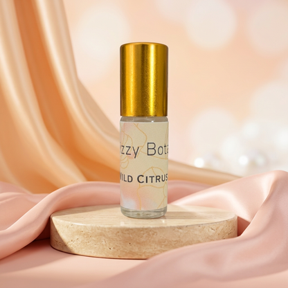 Perfume roller with pastel peach and blush satin background